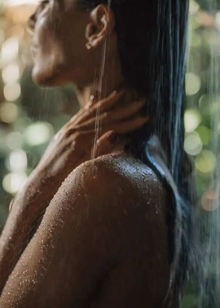 Mana Wellness spa guest in an outdoor shower